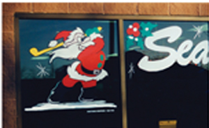 Painted Holiday Window Scene and Santa Golfing on Storefront
